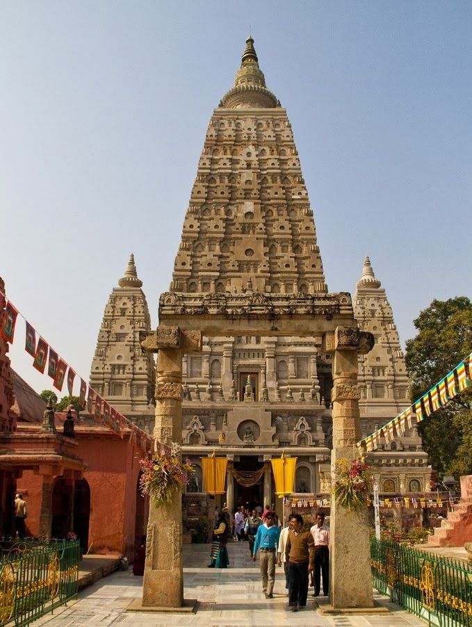 two people are standing in front of a temple