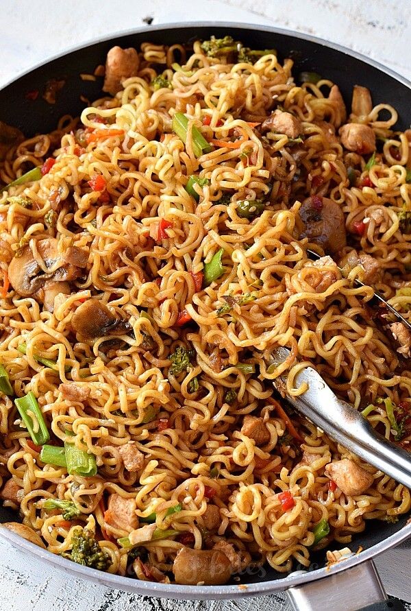 a skillet filled with noodles and vegetables