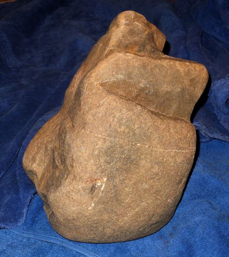 a large rock sitting on top of a blue blanket