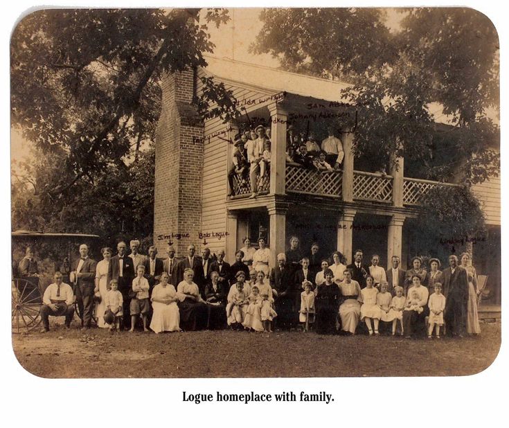 an old black and white photo of people in front of a house with porches