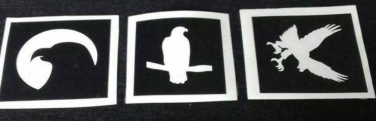 three black and white stickers with birds in the middle one has a bird on it's back