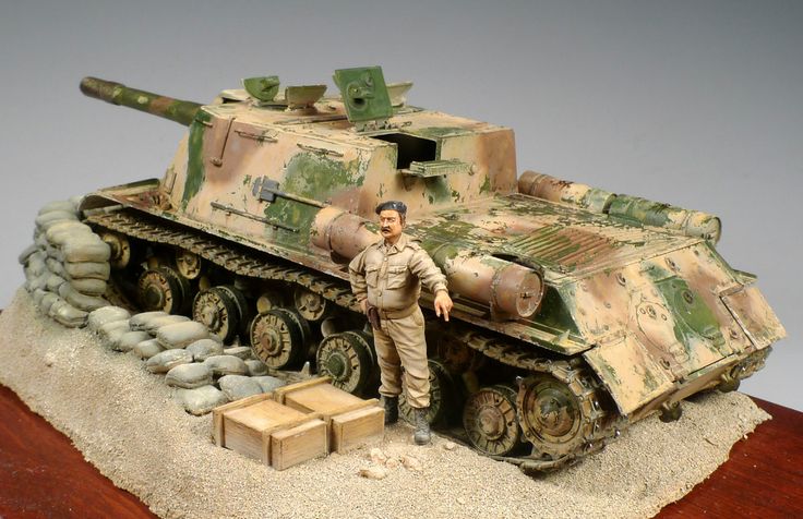 a figurine of a man standing next to a tank