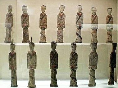 an exhibit case with many different types of statues