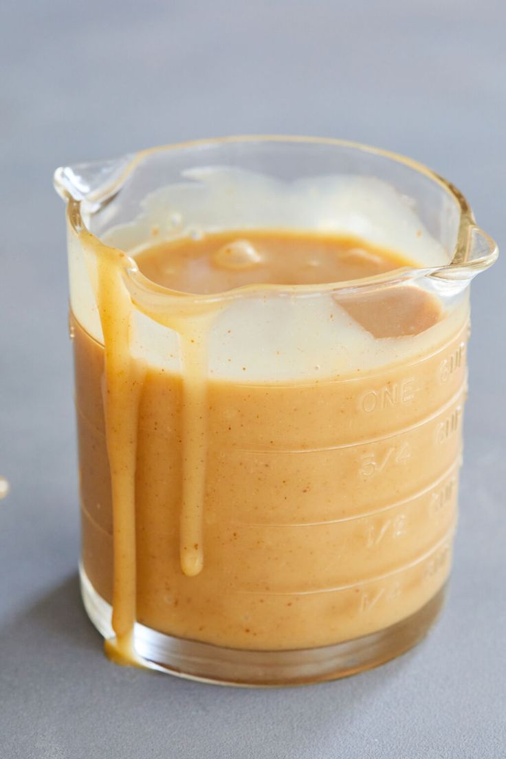 a small glass container filled with liquid on top of a table