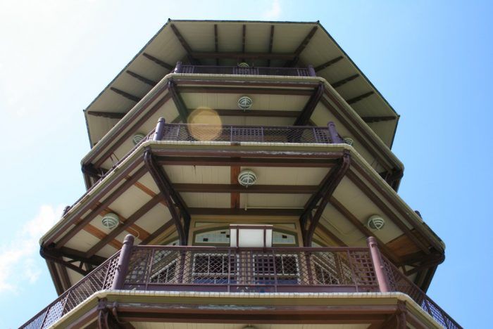 a tall building with lots of balconies on top