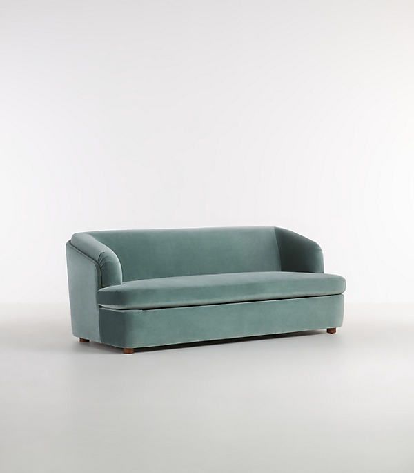 a blue couch sitting on top of a white floor