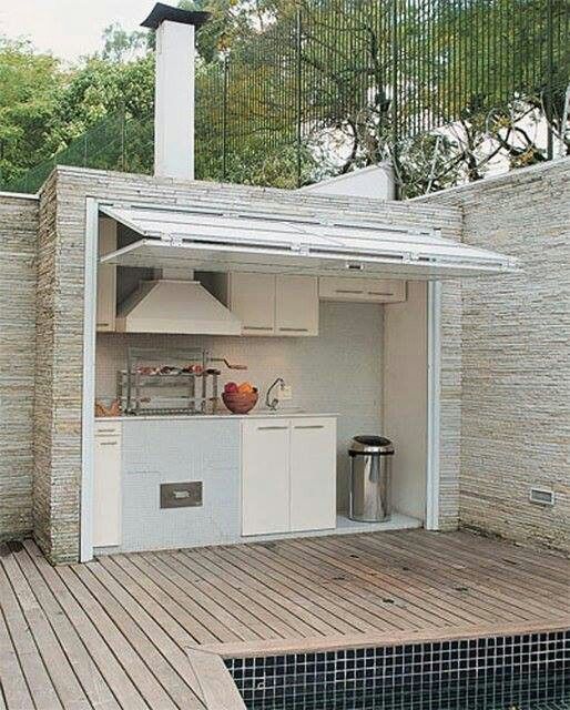 an outdoor kitchen is built into the side of a wall