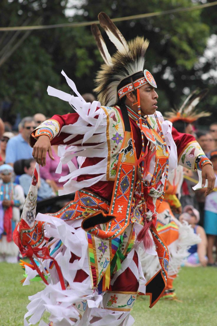 a native american dancer performing in front of a crowd