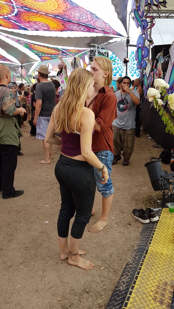 two women hug each other at an outdoor festival