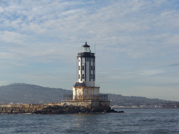 a light house sitting on top of a rock in the ocean