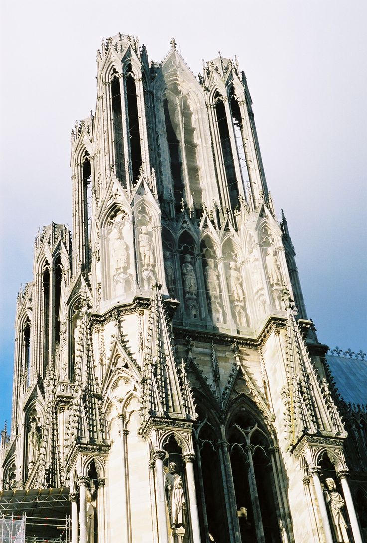 a large cathedral with many spires against a blue sky