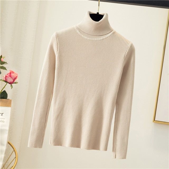 Upgrade your winter wardrobe with our Women's Oversized Sweater - a perfect blend of sleek and simple design. The thick and warm fabric. coupled with a stylish turtleneck. will keep you cozy and fashionable during the chilly season. Made of high-quality cotton and polyester. this sweater offers maximum comfort and durability. With a high elasticity rate. it's perfect for women of all sizes. This popular plain sweater is available in different colors and sizes to cater to your needs. Don't miss out on the chance to own this timeless piece of winter wear. Order now and experience the luxury of knitted comfort. Trendy Winter Turtleneck With Ribbed Collar, Elegant Ribbed Winter Outerwear, Trendy Ribbed Collar Turtleneck For Winter, Winter Stretch Ribbed Outerwear, Winter White Turtleneck Top, Chic Winter Sweater With Ribbed Collar, Cozy Winter White Turtleneck For Winter, Classic Funnel Neck Winter Outerwear, Beige Solid Color Winter Sweater