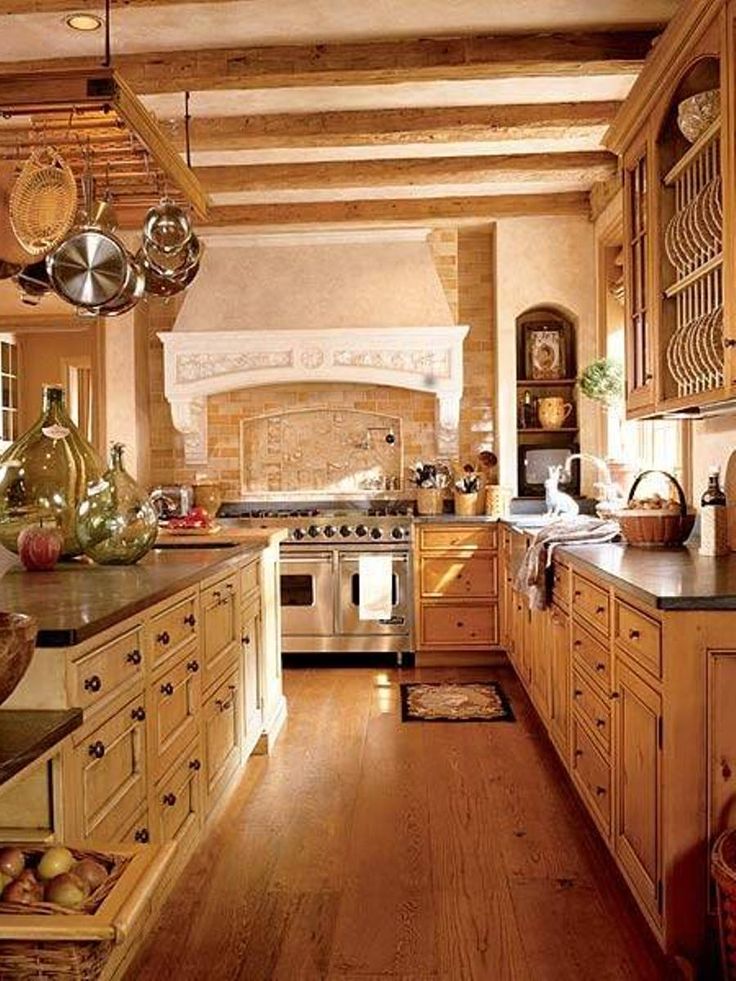 an old fashioned kitchen with wood floors and white appliances, along with hanging pots and pans