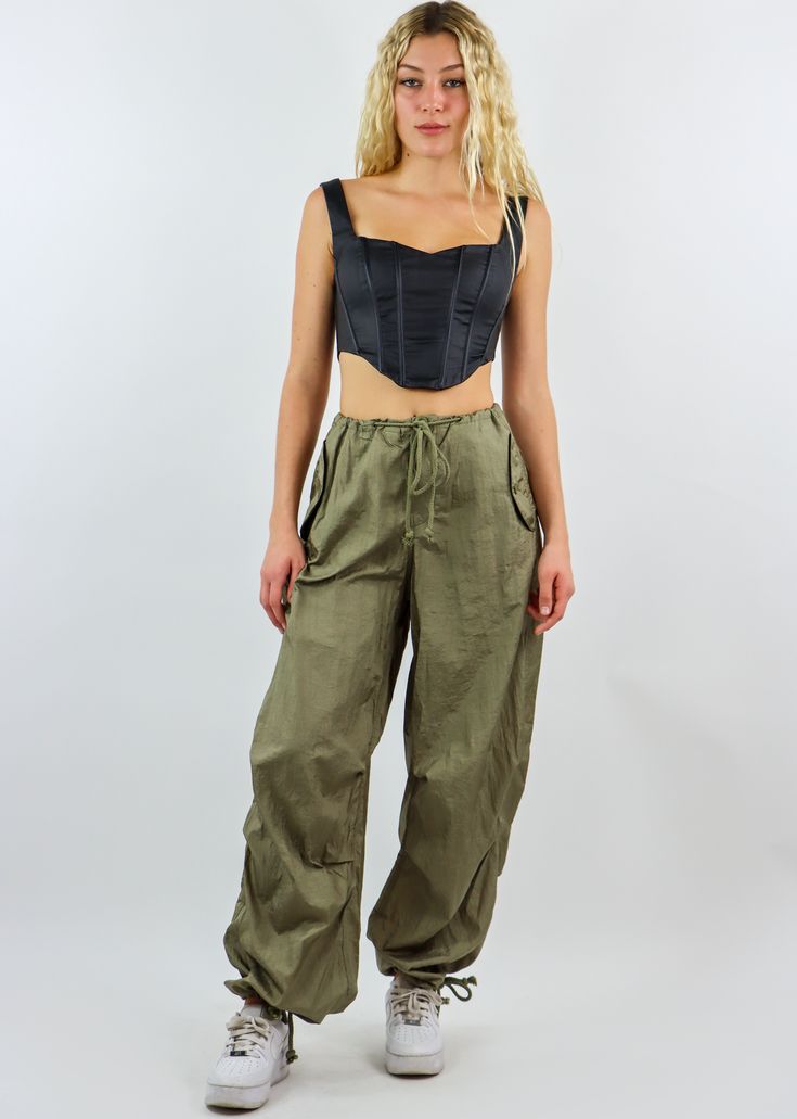 We are obsessed with these must have parachute pants! They feature an adjustable waist and ankle detailing with an oversized fit throughout the body. They are the most comfortable and trendy bottoms in fashion right now, and we can't wait to see you rock them! Wear them with your favorite crop top or oversized hoodie. Model Info Meet Zoe! Here she is wearing a size small. Hips: 35” | Waist: 25” | Bust: 32” | Height: 5’7” The Details Parachute Pants Adjustable Waist Adjustable Ankle Hand Wash Col Military Style Baggy Wide Leg Parachute Pants, Baggy Combat Parachute Pants With Wide Legs, Combat Style Baggy Wide Leg Parachute Pants, Loosely Fitted Cargo Parachute Pants For Spring, Summer Combat Cotton Bottoms, Spring Utility Parachute Pants In Khaki, Spring Military Style Parachute Pants With Cargo Pockets, Spring Military Parachute Pants With Cargo Pockets, Urban Style Straight Leg Parachute Pants For Summer