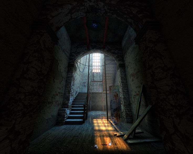 a dark tunnel with stairs leading up to the light