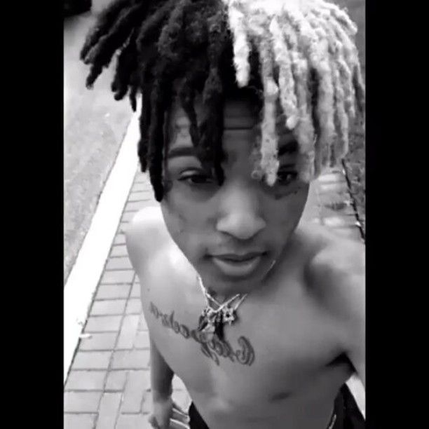 a young man with dreadlocks on his head and no shirt is posing for the camera