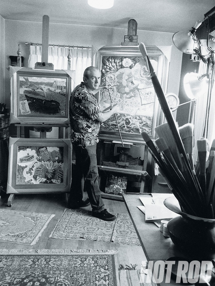 a man standing in front of an art work