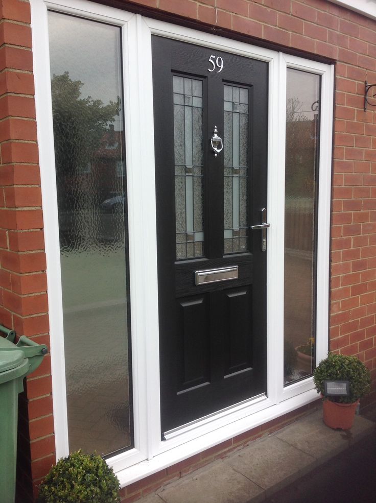 an image of a black front door with glass side panels on the outside and inside