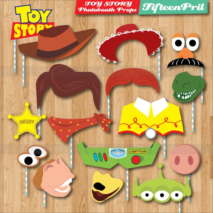 some paper masks are hanging on a wooden floor with eyes, nose and mouth decorations