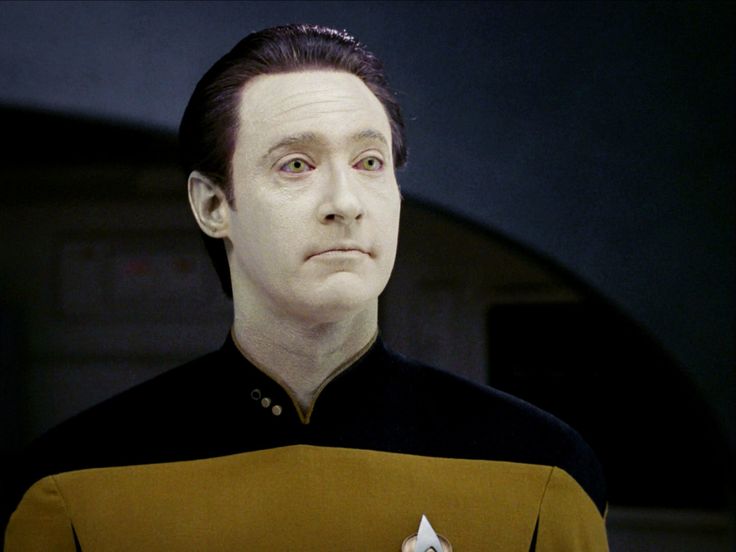 a man in star trek uniform looking at the camera