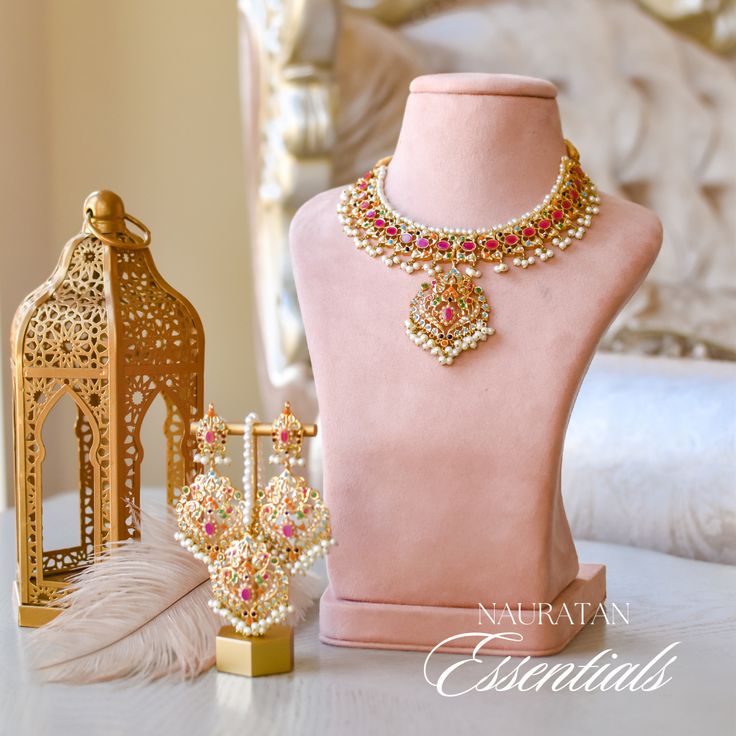 A dazzling fusion of tradition and modern allure - perfect for this festive season to pop some color in your radiant celebrations! Elevate your style with this enchanting ensemble that seamlessly blends the richness of nauratan stones with the classic charm of faux pearls. The set includes a necklace, a maang teekah and a pair of matching earrings. Approximate earrings length is 3.2". Gold-plated on high-quality brass as the base metal. In-stock & ready-to-ship. *Please Note: We use faux stones Gold Kundan Necklace For Festive Spiritual Occasions, Ornate Gold Meenakari Jewelry Sets, Luxury Red Kundan Bollywood Necklace, Ornate Brass Kundan Necklace For Gift, Gold Meenakari Ornate Jewelry Sets, Unique Gift Cards, A Necklace, Faux Stone, Festive Season