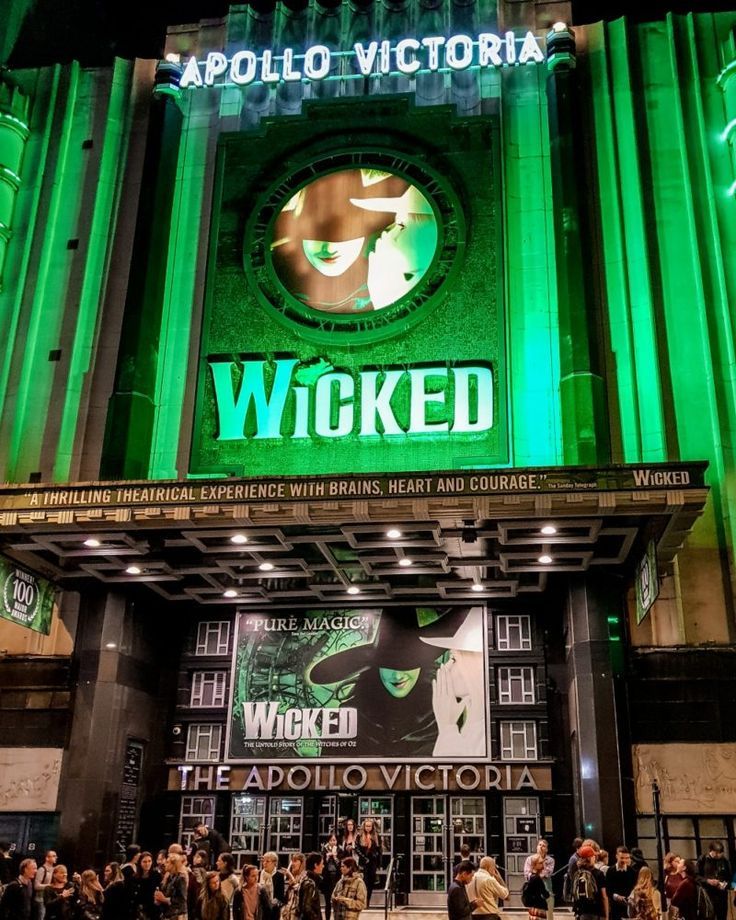 an advertisement for the wizard in london's west end at night with people standing outside