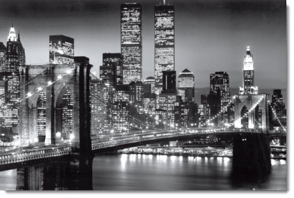 black and white photograph of new york city at night with the brooklyn bridge lit up