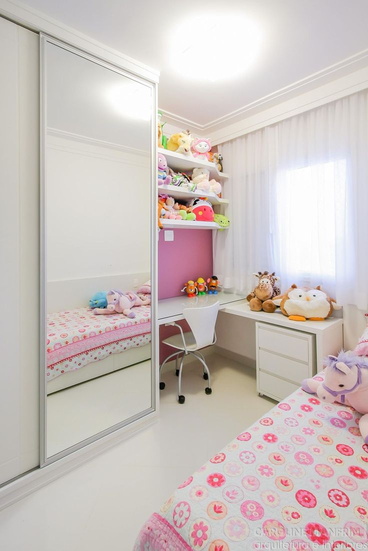 a child's bedroom with pink and white decor