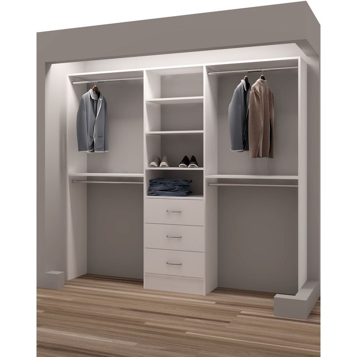 an open white closet with clothes and shoes on the shelves, next to a wooden floor