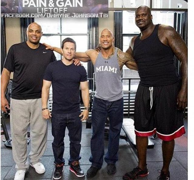 the men are posing for a photo in the gym