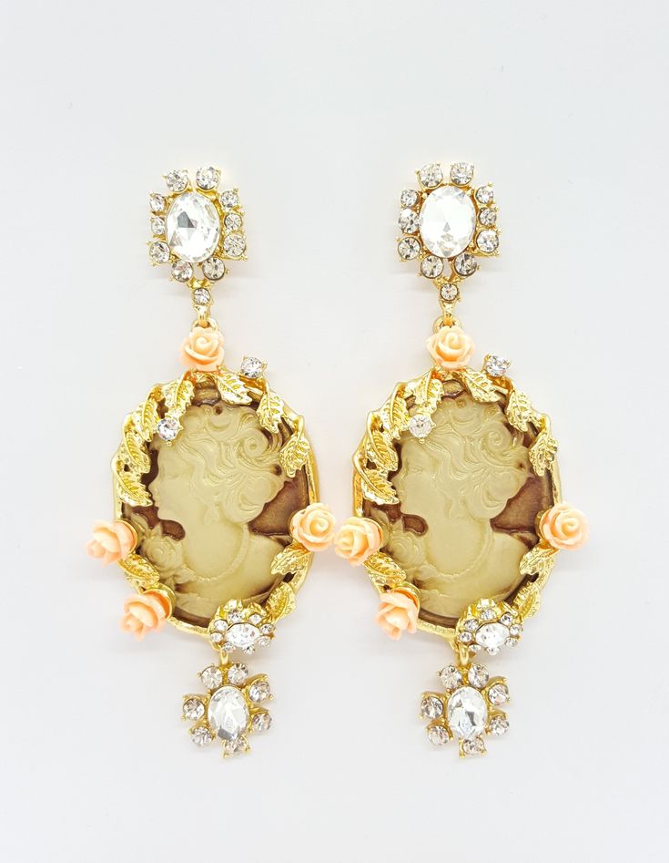 These stunning Cameo earrings feature a large Cameo shell, embellished by sparkling crystals and small resin roses, all set in within an gold tone setting. Stud fasting. Perfect as a Birthday gift, Anniversary or Other Special Occasion.Earrings measure approximately 9cms/3.54 inches by 3.5cms/1.37 inches. Victorian Style Earrings, Cameo Earrings, French Jewelry, Sparkling Crystal, Style Earrings, Victorian Style, Victorian Fashion, Birthday Gift, Special Occasion