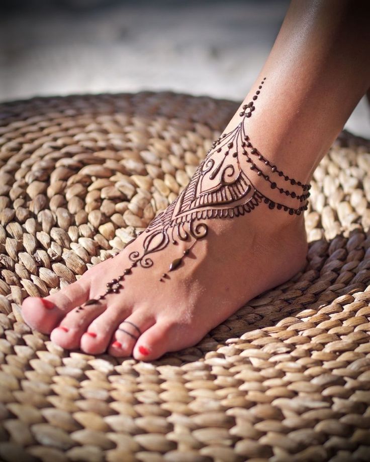 a woman's foot with hendix on it and the bottom part of her leg