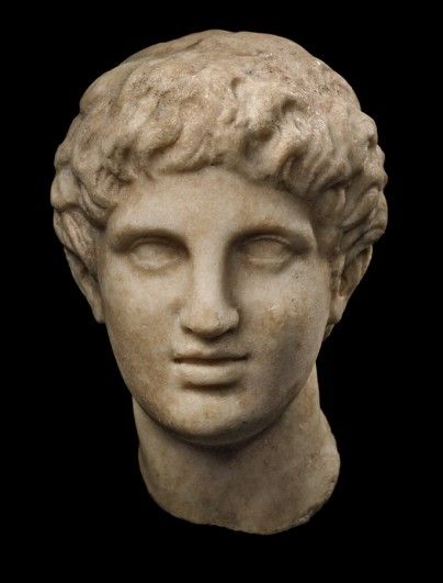 a white marble bust of a man's head with curly hair and eyes closed