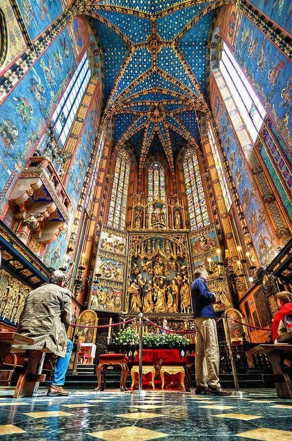 two men are standing in the middle of a church