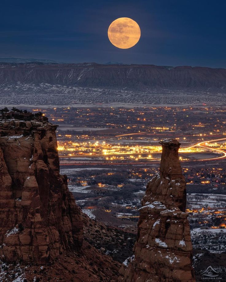 the full moon is seen over some mountains in this view from pike point, utah