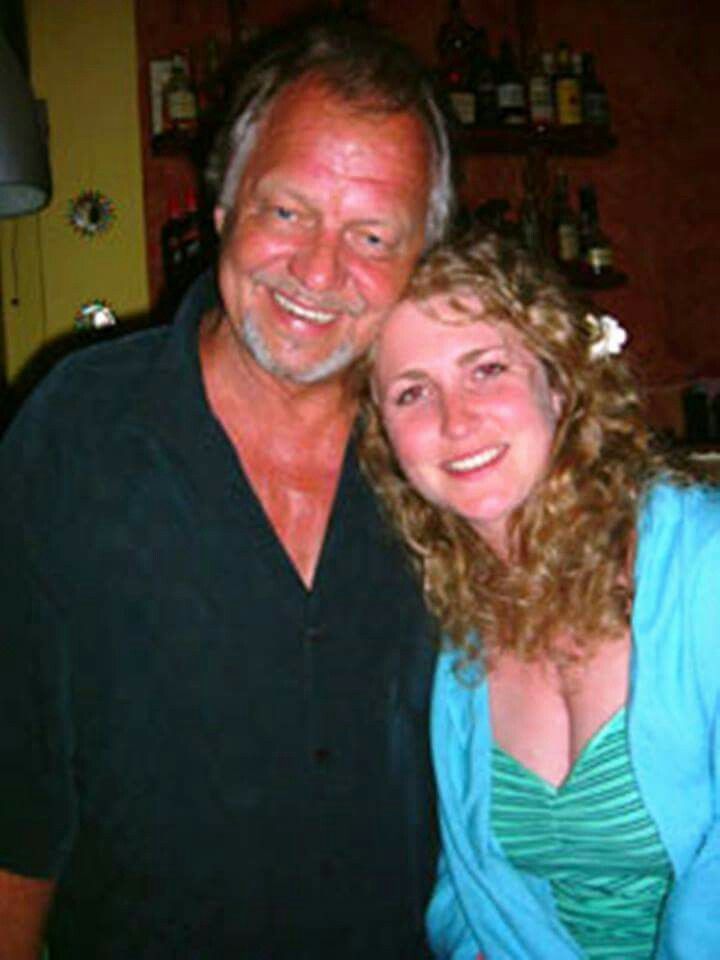 a man standing next to a woman in a kitchen