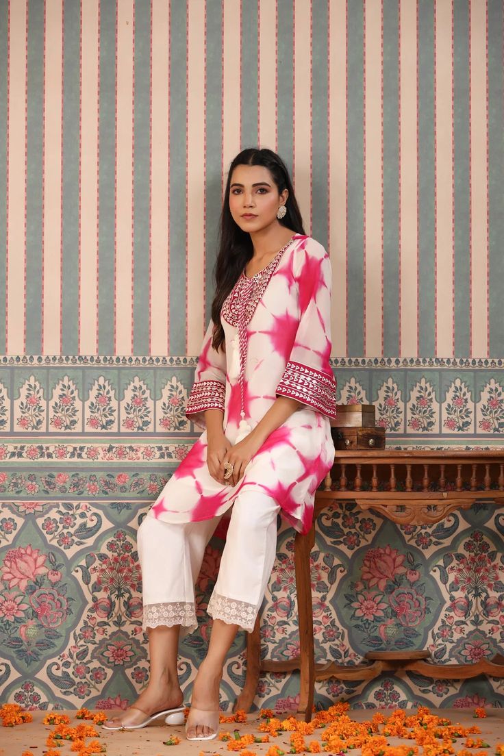 Indulge in elegance with our Pink Tie And Dye Suit Set. The beautiful pink hue and handwork make it the perfect statement piece for any occasion. Crafted from luxurious organza, the delicate tassels add a touch of charm to this unique and sophisticated ensemble. Elevate your wardrobe with this exclusive piece. No. of pieces - 2 piece set. Color - Pink. Kurta Fabric - Organza. Washing Instructions - Dry Clean. Pink Kurta, Pink Tie, Tie And Dye, Pink Ties, Suit Set, 2 Piece Set, Washing Instructions, Statement Pieces, 2 Piece