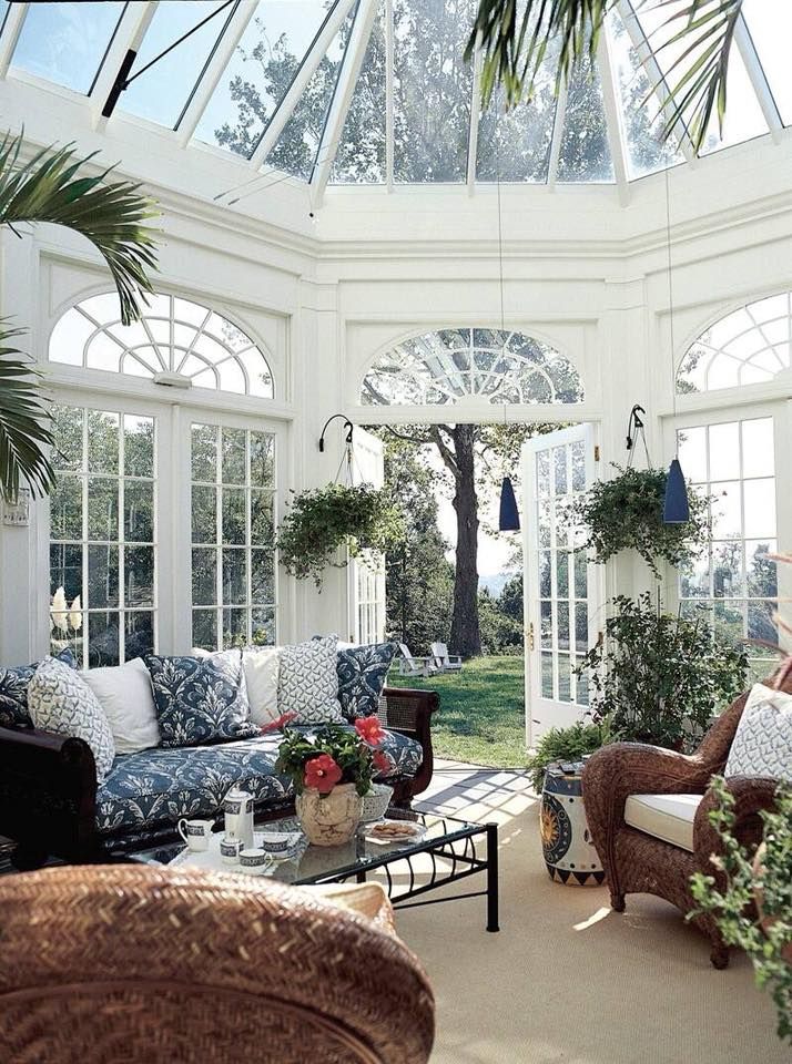 a living room filled with furniture and lots of windows