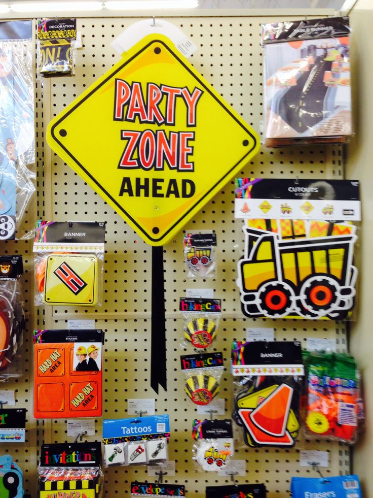 there is a party zone ahead sign on the pegboard in front of some toys