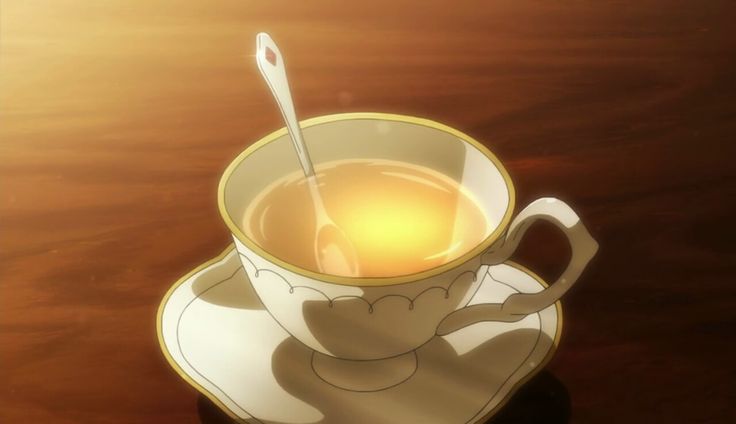 a cup of tea on a saucer with a spoon in it sitting on a table