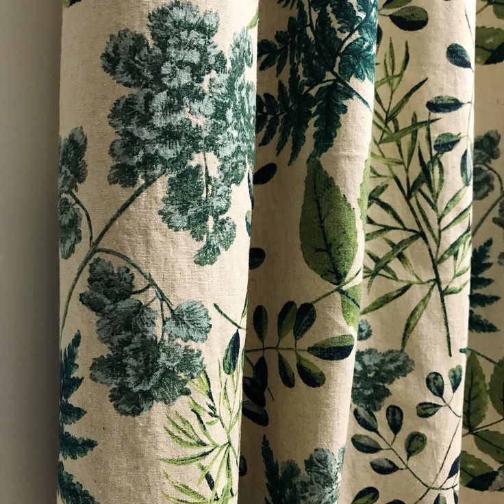 the curtains are covered with green leaves