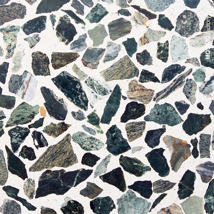 a close up view of some rocks on the ground with white and black colors in it