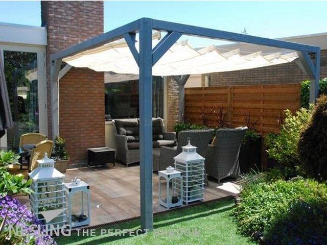 an outdoor living area with patio furniture and white umbrellas over the top of it