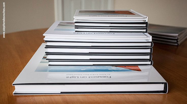 a stack of books sitting on top of a wooden table