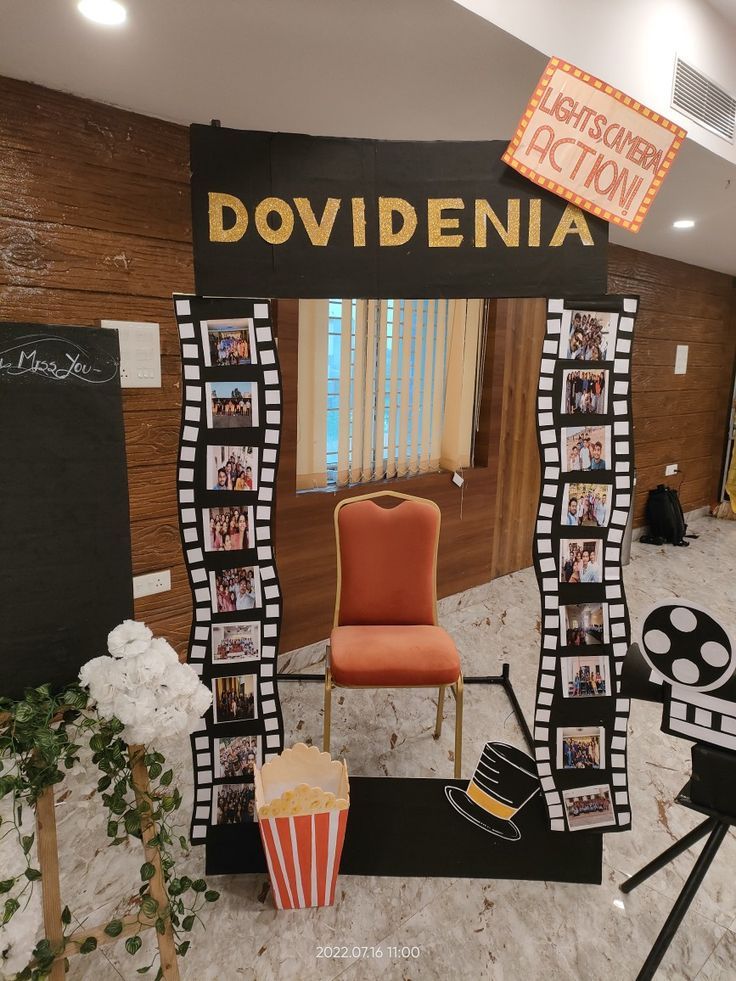 a chair and movie props in front of a sign that says doviddenia