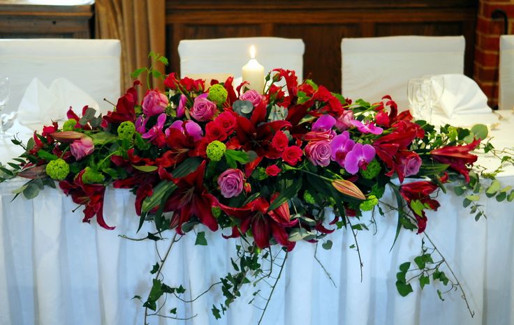 a table with flowers and candles on it