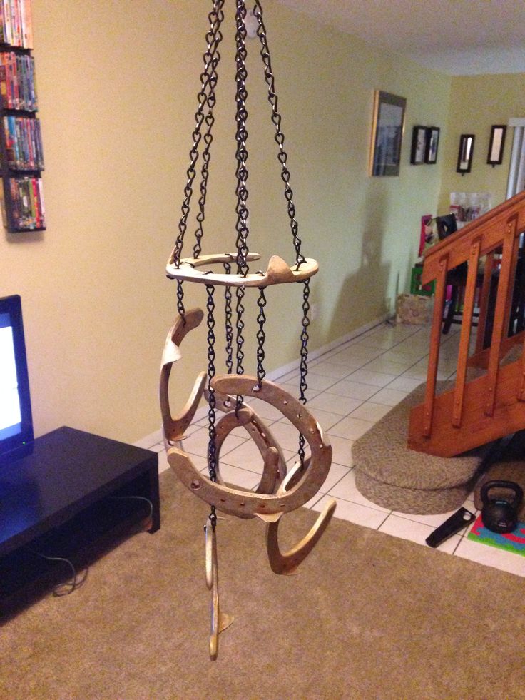 a living room with a television and some kind of hanging object in the middle of it