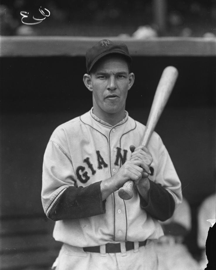 an old black and white photo of a baseball player holding a bat