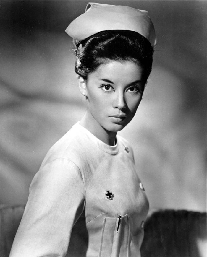 a black and white photo of a woman wearing a sailor's hat