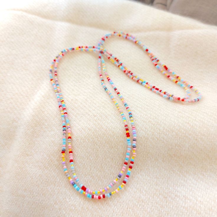 "This is a one strand beaded multi color necklace, with NO CLASP, and can be worn in multiple ways, as shown in pictures. Matching bracelet found here: https://www.etsy.com/listing/1037602923/pink-and-yellow-beaded-bracelet ❤ SIZES This item is one size fits all. ❤ PROCESSING AND SHIPPING Most orders are made and shipped out in one business day. Please check delivery timeframes for your location on the description below. ❤ CUSTOM ORDERS If you like this item in a different color, send me a messa Summer Multi-strand Colorful Beaded Necklaces, Summer Multi-strand Beaded Necklaces As Gifts, Beach Jewelry With Tiny Beads, Multi-strand, Colorful Multi-strand Beaded Necklaces For Summer, Summer Gift Multi-strand Beaded Necklaces, Multi-strand Beaded Necklaces For Summer, Beaded Long Necklace For Summer, Summer Multi-strand Beaded Jewelry, Colorful Lariat Beads For Jewelry Making